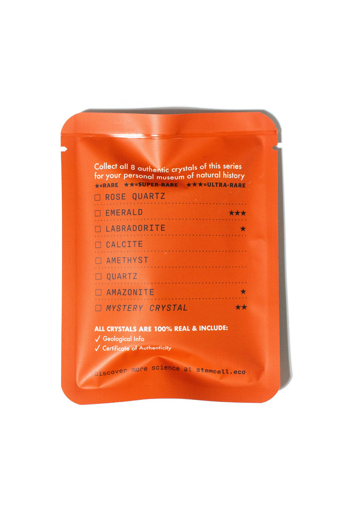 Orange crystal blind bag with a large geometric crystal illustration and Stemcell branding