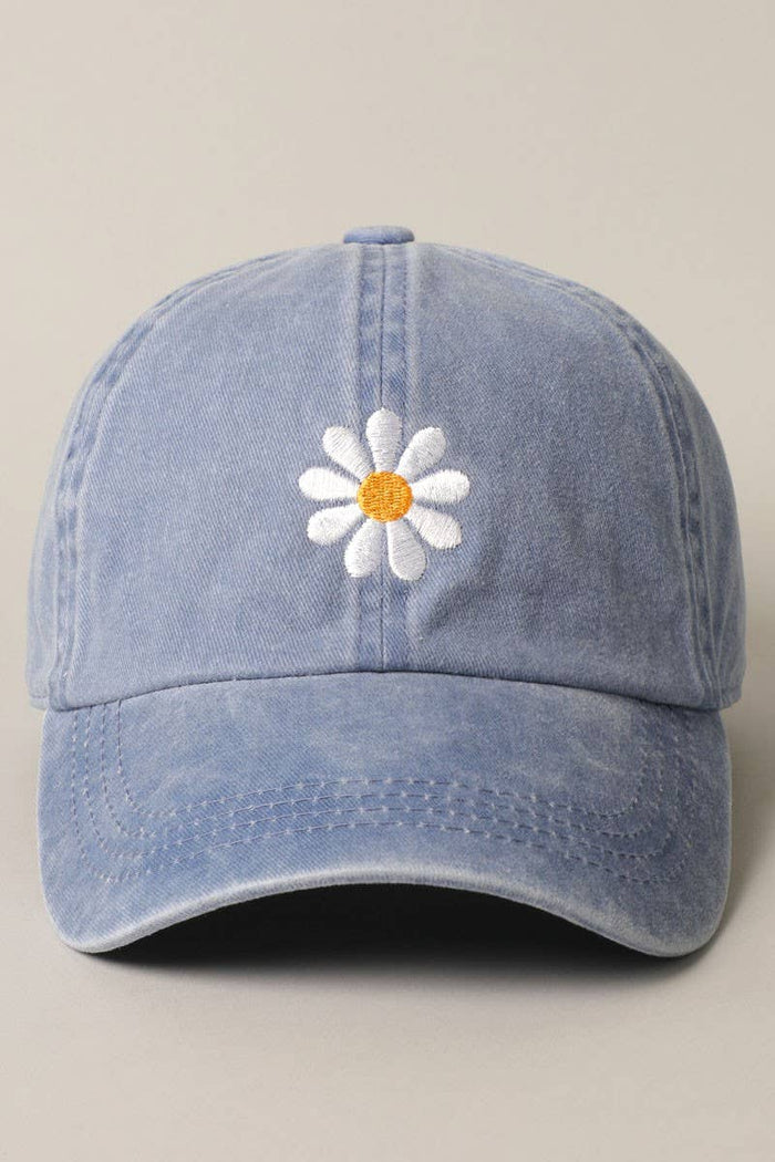 Light blue denim cap with a white daisy embroidery and orange center