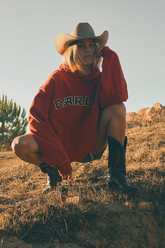 Darlin’ Varsity Oversized Hoodie in red featuring bold varsity-style DARLIN’ lettering across the chest