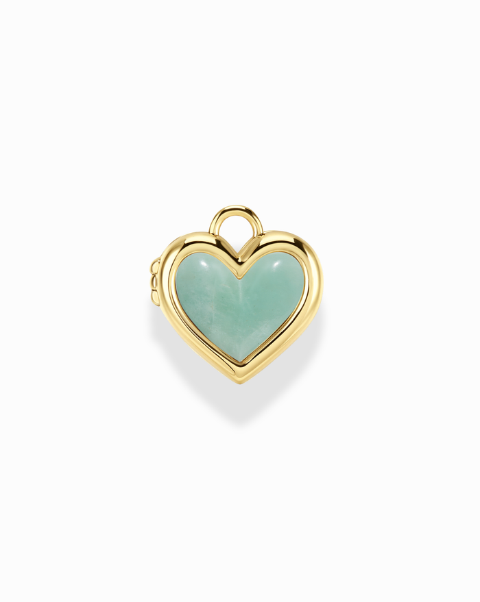 Heart-shaped locket with gold frame and green gemstone on a white background