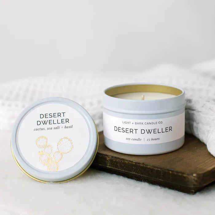 Desert Dweller 4oz candle in a pale blue tin with lid, label mentions cactus sea salt and basil