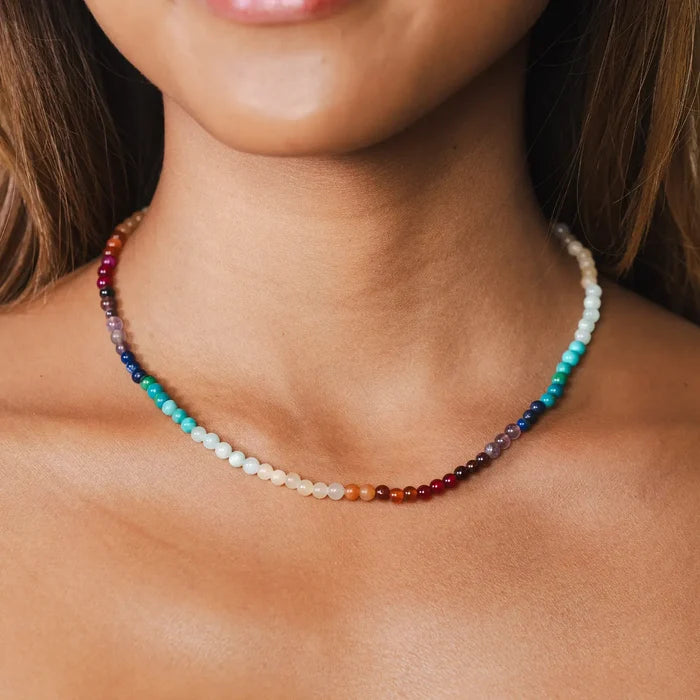 Divine Healer Beaded Necklace worn on a model with a colorful strand around the neck.