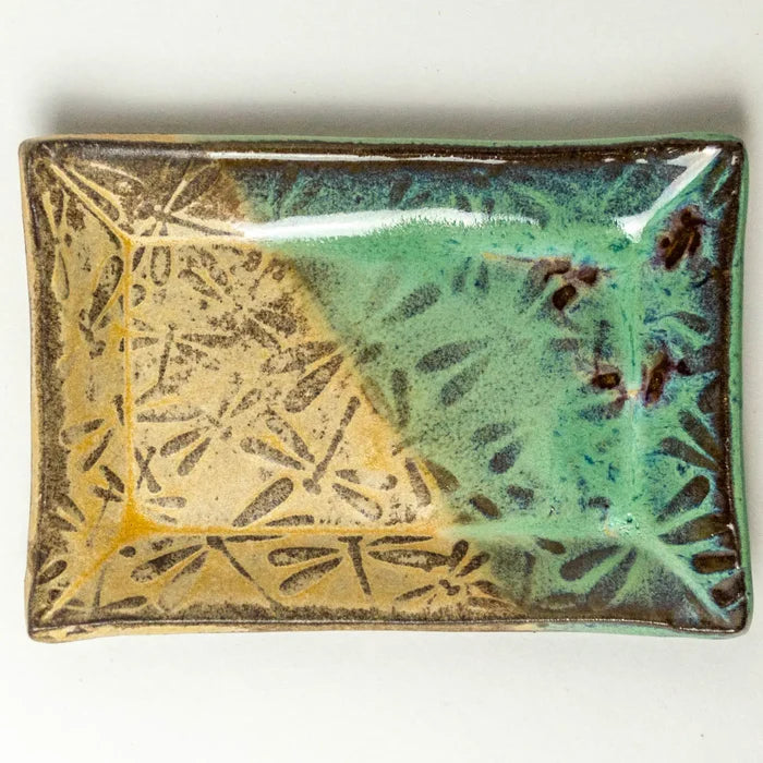 Square ceramic trinket tray featuring a gold dragonfly motif on a green and beige glaze.