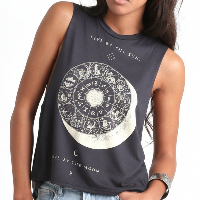 Woman in a dark sleeveless Eclipse top with a large circular celestial print on the front.
