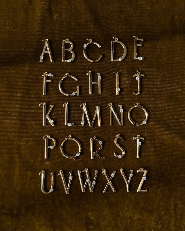 The Eloise Letter Charm by Mod + Jo features gold alphabet pendants with sparkling cubic zirconia in four rows, displaying A to Z—perfect as a gold initial necklace or letter charm for any style.