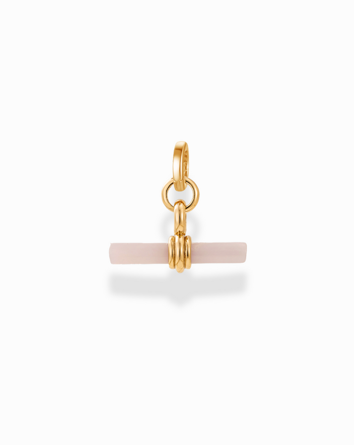 Close-up of the Ethel Gemstone Toggle Charm in gold with a pale pink gemstone, highlighting its design details.
