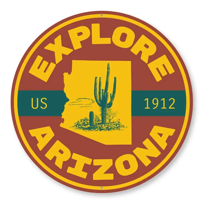 Round Explore Arizona sign with yellow border featuring a desert scene and cactus inside the Arizona silhouette.