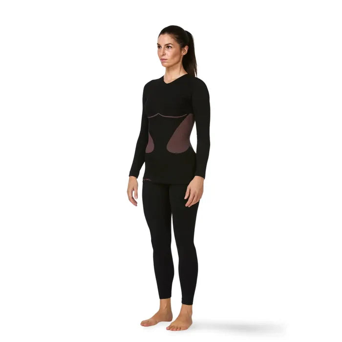 Woman wearing a Sub Zero Factor 1 Plus Womens Long Sleeve Base Layer Stretch Top Pink Black on a white background