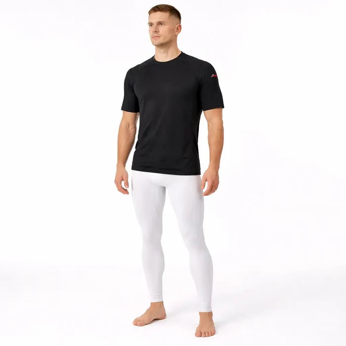 Man wearing a Sub Zero Factor 2 mens short sleeve thermal mid layer top in black with white base layer leggings on a white background