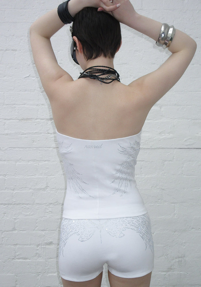 Back view of a model wearing a white tube top with rhinestone wing design.