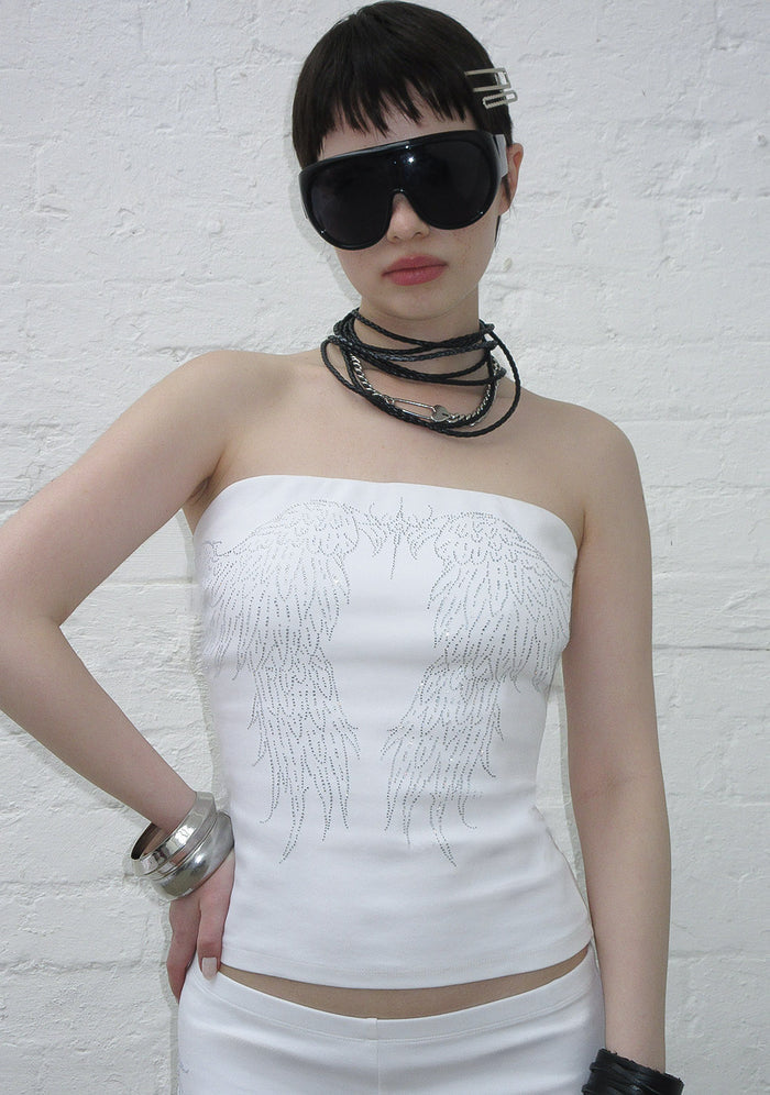 Model wearing a white tube top with rhinestone wing design, showcasing the fallen rhinestone tube top white.