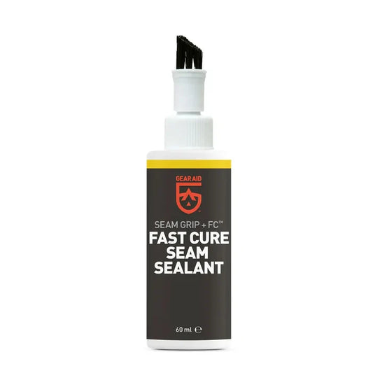 Gear Aid Seam Grip + FC Fast Cure Seam Sealant in a 60 ml bottle, featuring a dark gray label with a yellow stripe and red logo, topped with a white spray cap and black applicator tip.