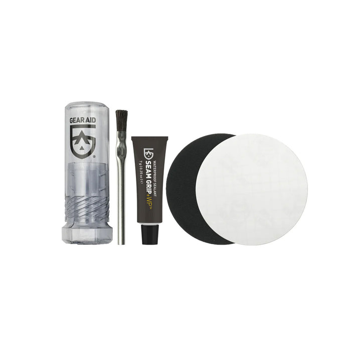 Contents laid out on a white background of Gear Aids Seam Grip waterproof field repair kit