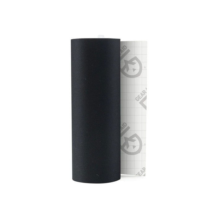 Roll of Gear Aid Tenacious repair tape in black showing part of the backing tape photographed on a white background