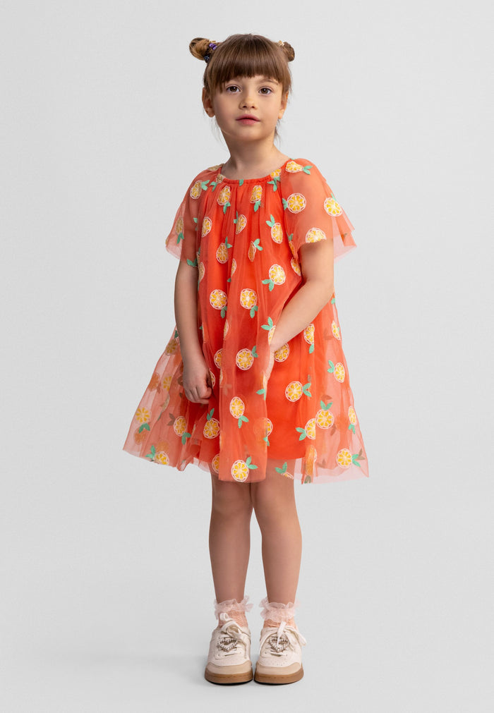 Girls apricot tulle party dress with angel sleeves and side pockets, front view.