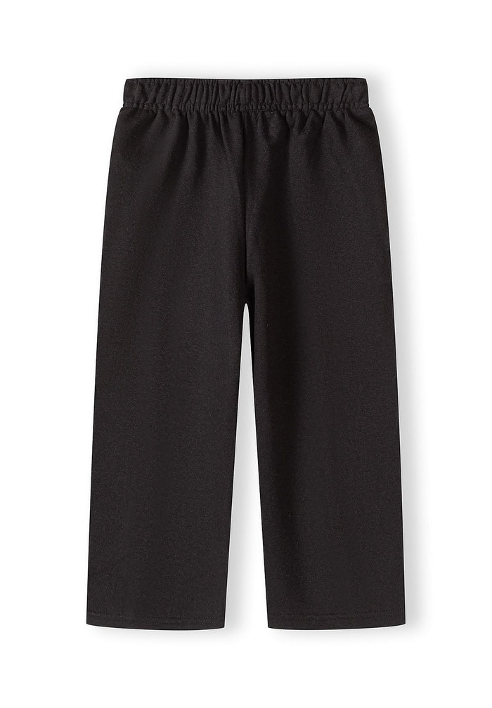 Black loose fit trousers for girls, front view, featuring an elastic waistband.
