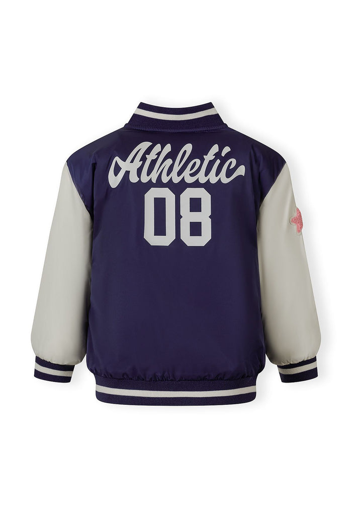 Girls varsity bomber jacket in navy and white, back view with 'Athletic 08' print.