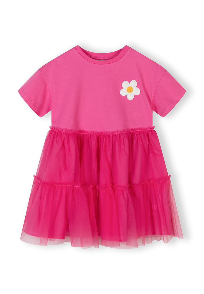 Girls' pink jersey dress with layered tulle skirt and crochet flower, front view.