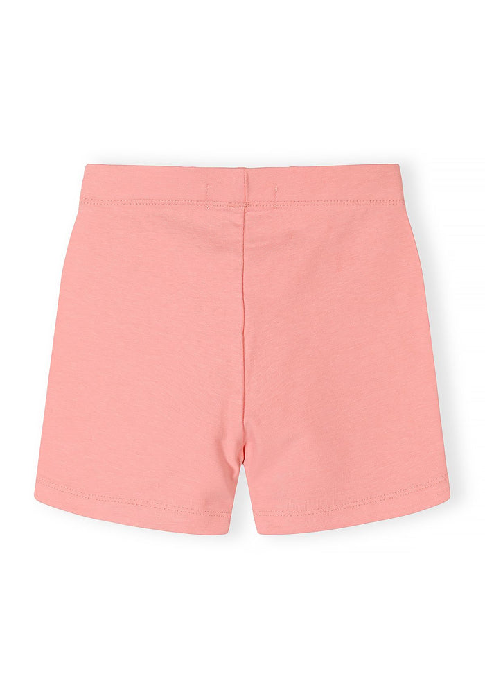 Girls bike shorts in pastel pink, back view, featuring a slim fit and elasticated waistband.