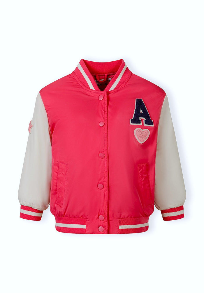 Girls varsity bomber jacket in bright pink, front view with snap button closures and side pockets.