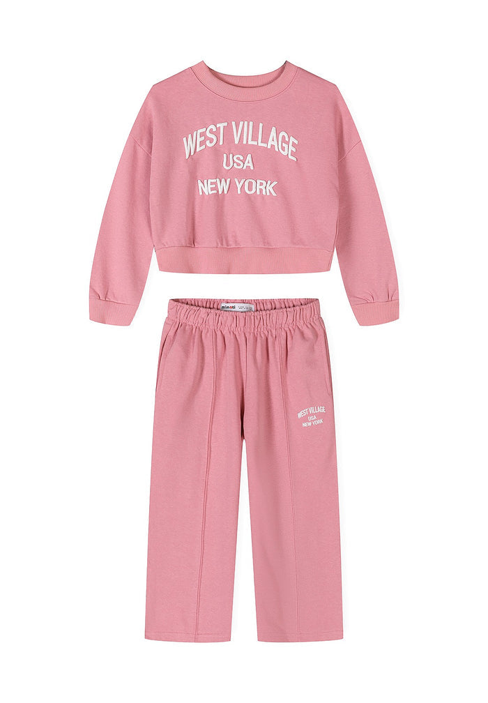 A two-piece kids' lounge set in dusty pink, featuring a cropped long-sleeve sweatshirt with 'WEST VILLAGE USA NEW YORK' printed in white on the chest, and matching wide-leg sweatpants with an elastic waistband and a small white logo on the left leg.