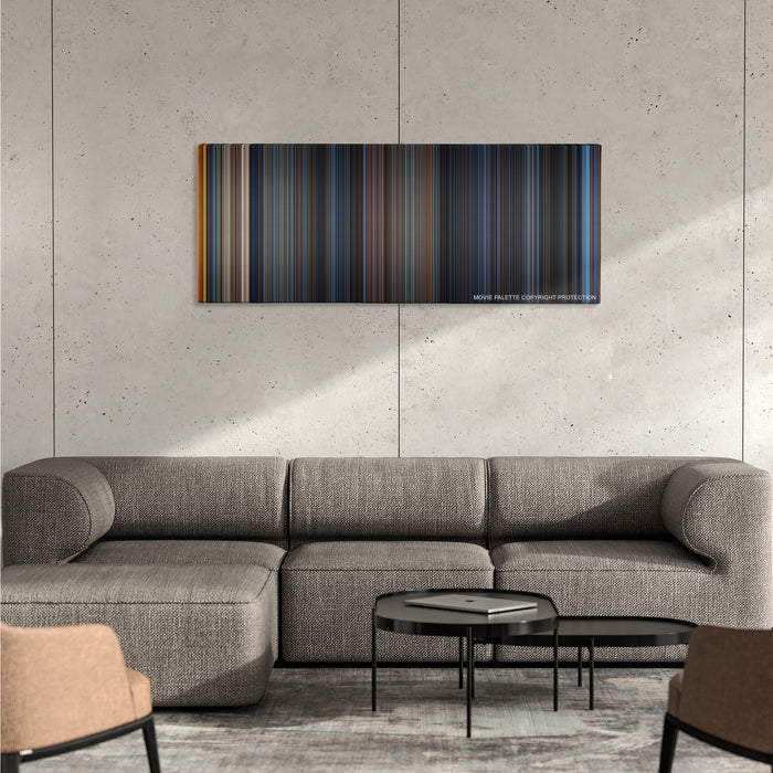 Godzilla color palette canvas on a concrete wall above a gray sectional sofa