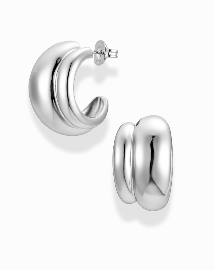 silver double dome hoop earrings on a white background