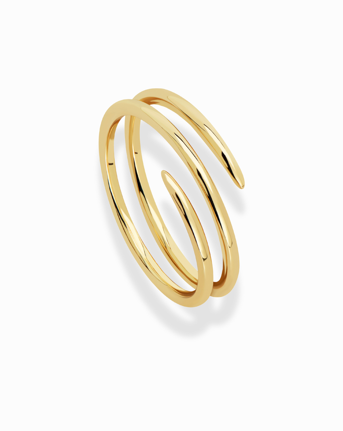 Close-up showcasing the design of the gold Greer Spiral Ring. Modern jewelry aesthetic, trendy statement ring.