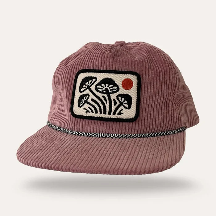 Pink corduroy flatbrim hat with a rectangular embroidered mushroom patch on the front