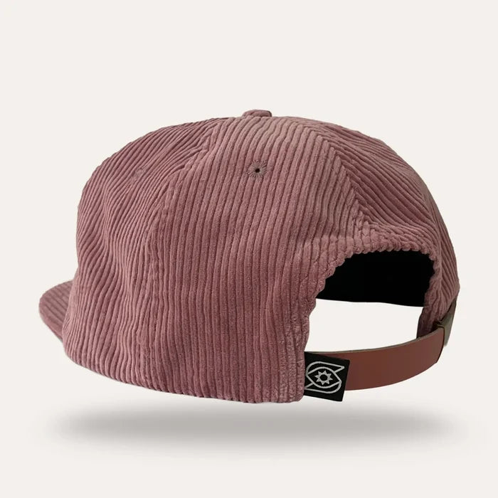 Rear view of pink corduroy Groovy Mushrooms flatbrim hat with a brown adjustable strap and logo tag