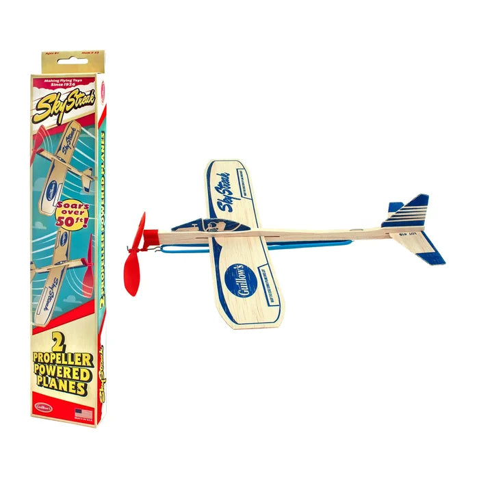 Box for Guillow's Sky Streak power planes and a wooden model airplane with a red propeller.