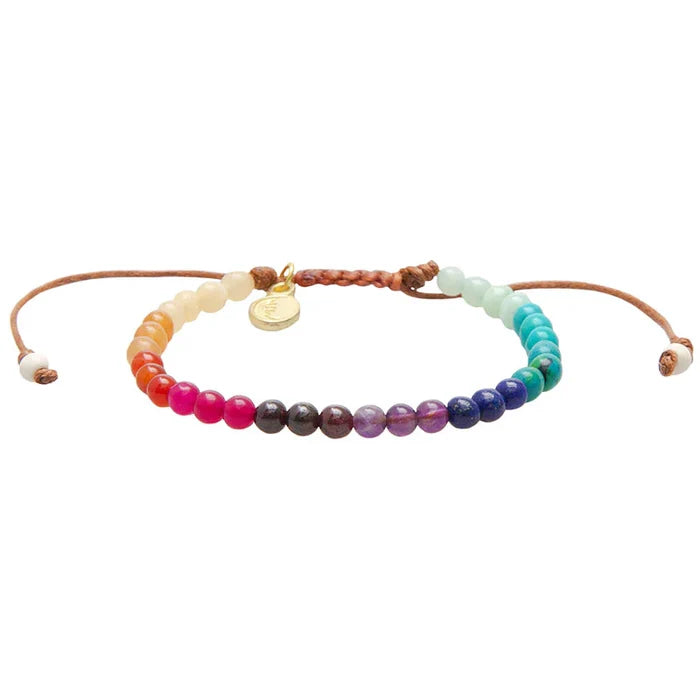 Rainbow beaded healing crystal bracelet with a small gold charm on an adjustable brown cord