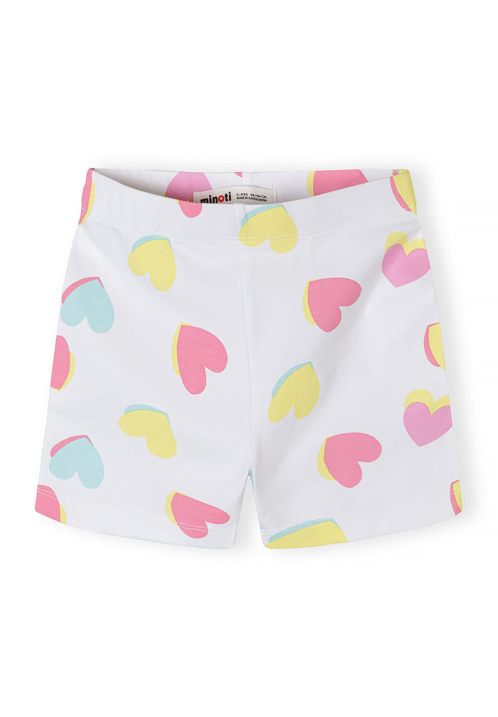 Detail of girls' cycle shorts in white with colorful heart prints and elasticated waistband.