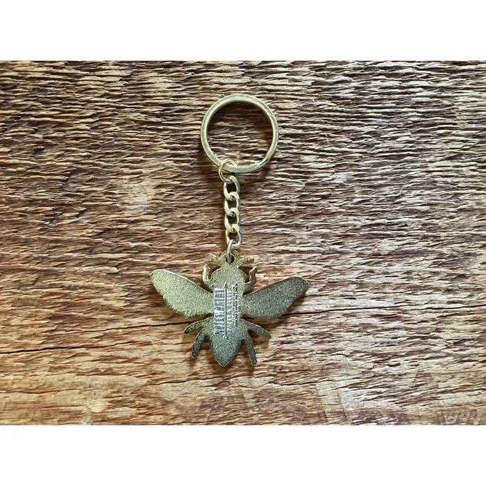 Close up of gold honey bee keychain showing the bee charm and linked chain
