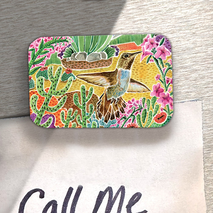 Hummingbird Desert Scene wood magnet shown on a desk.