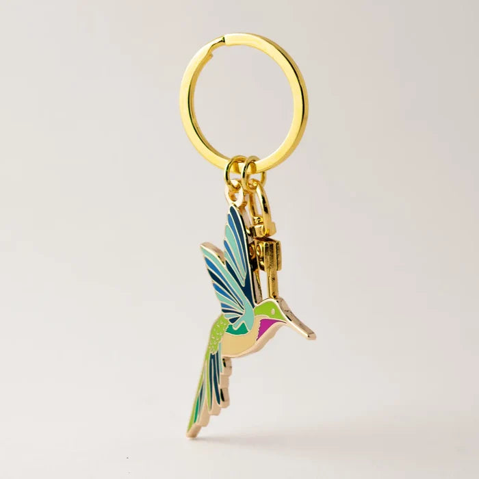 Gold ring keychain with a multicolored hummingbird charm.