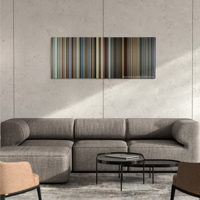 I, Tonya color palette canvas on a concrete wall above a gray sectional sofa