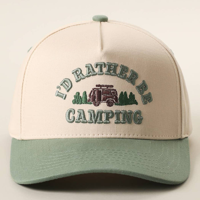 Front view of a beige trucker hat with a sage green brim, featuring camping embroidery with a van and trees.