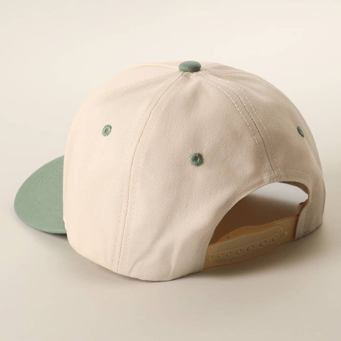 Back view of beige trucker cap showing plastic adjustable strap and mint green eyelets
