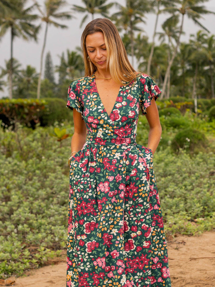 Back view of Isla Dress Wildflowers print with waist tie worn outdoors.