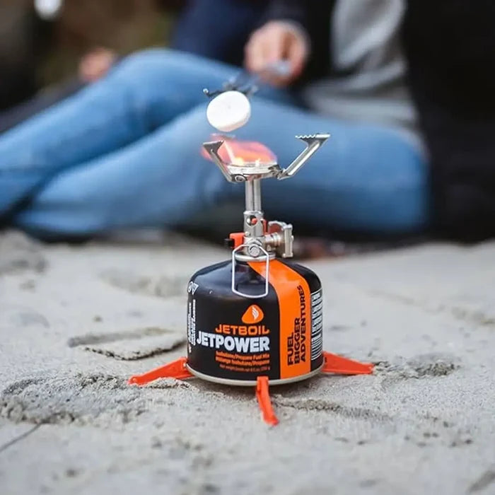 Lifestyle image of a Jetboil Fuel Can stabiliser legs being used on a gas canister whilst toasting a marshmallow