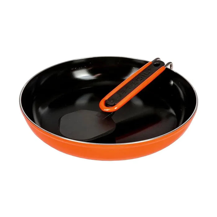 Jetboil Summit Skillet with the handle folded that also shows the spatula storage system