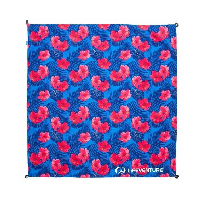 Overhead shot of a Lifeventure picnic blanket in the Oahu floral pattern opened out showing the four corner peg loops