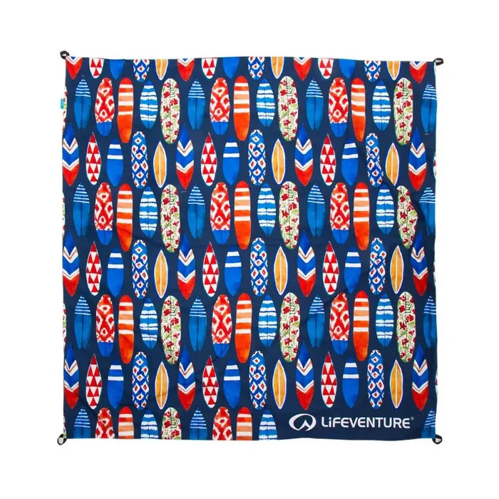 Overhead shot of a Lifeventure picnic blanket in the Surfboard pattern opened out showing the four corner peg loops