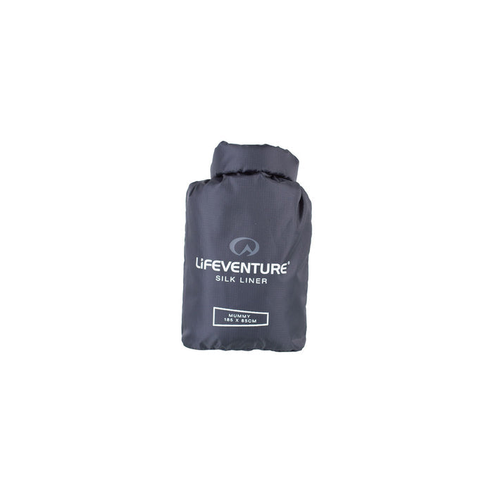 Lifeventure silk sleeping bag liner in the mummy shape packed in its stuff sack on a white background
