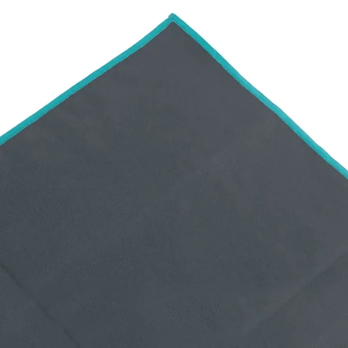 Close-up shot of the corner of a large Lifeventure SoftFibre recycled travel towel in grey showing the sealed stitched edges