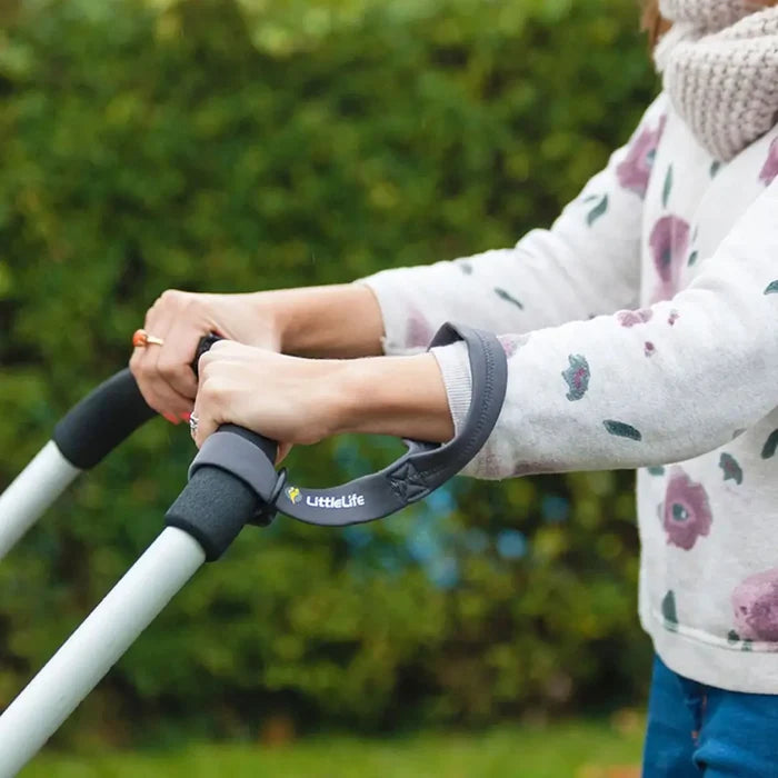 Lifestyle shot of a person using a Littlelife buggy wrist strap with their pram