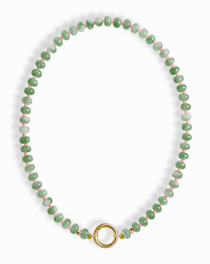 The Macey Gemstone Necklace by Mod + Jo features green jade and pink marbled beads with gold accents and a round gold clasp at the center.