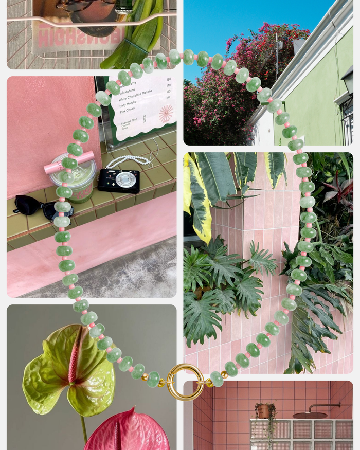 A vibrant collage with green and pink elements: the Mod + Jo Macey Gemstone Necklace with jade and pearl-like beads and a gold clasp, lush plants, a pink-tiled wall, a camera, and colorful buildings beneath a blue sky.
