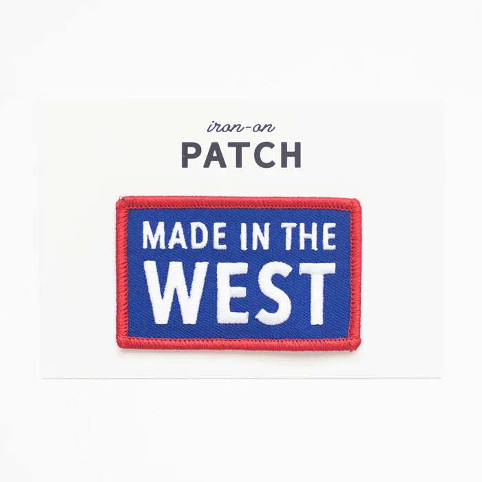 Blue rectangular iron-on patch with MADE IN THE WEST text in white and a red border